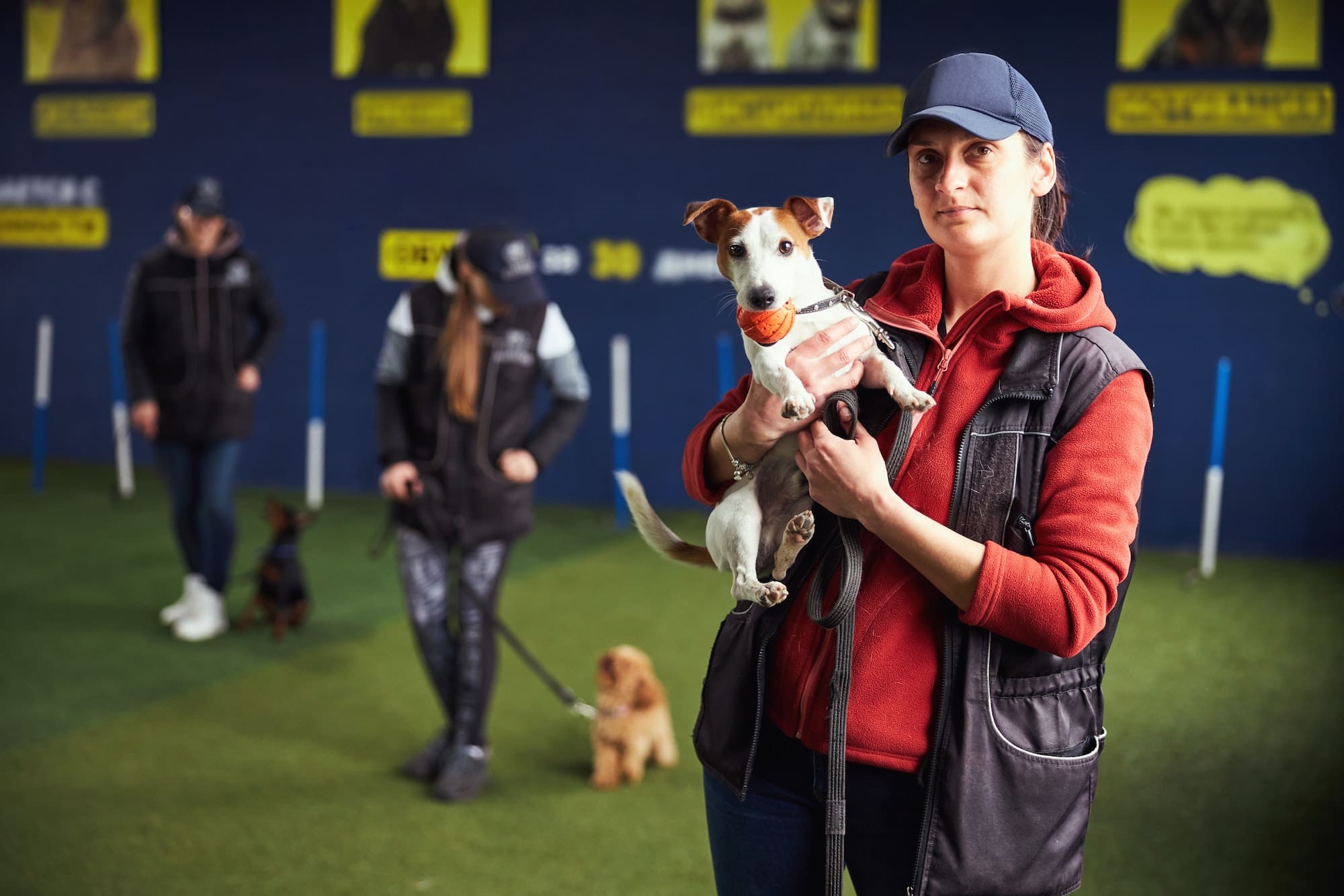 Dog trainer and a cute puppy posing for the camera